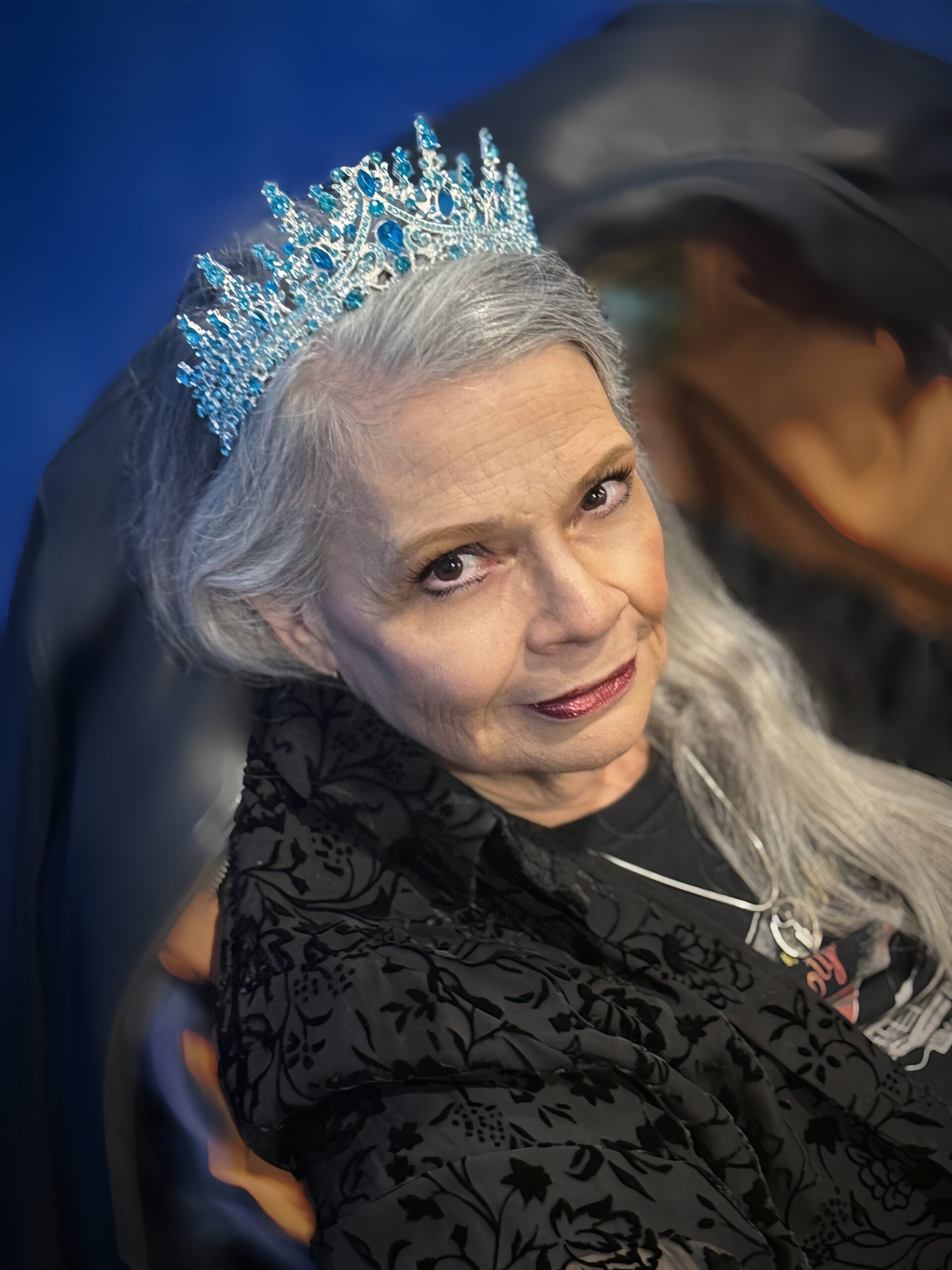 New England Acts performer in a silver and blue crown